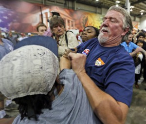 A supporter of Republican presidential hopeful Donald Trump scuffles with a protestor during a rally in Richmond.
