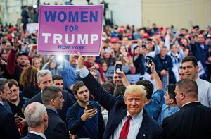Republican presidential candidate Donald Trump hold up a 'Women for Trump' sign as he greets the crowd after speaking during a campaign event at Grumman Studios in Bethpage, NY on Wednesday April 06, 2016. (Jabin Botsford/The Washington Post/Getty Images)
