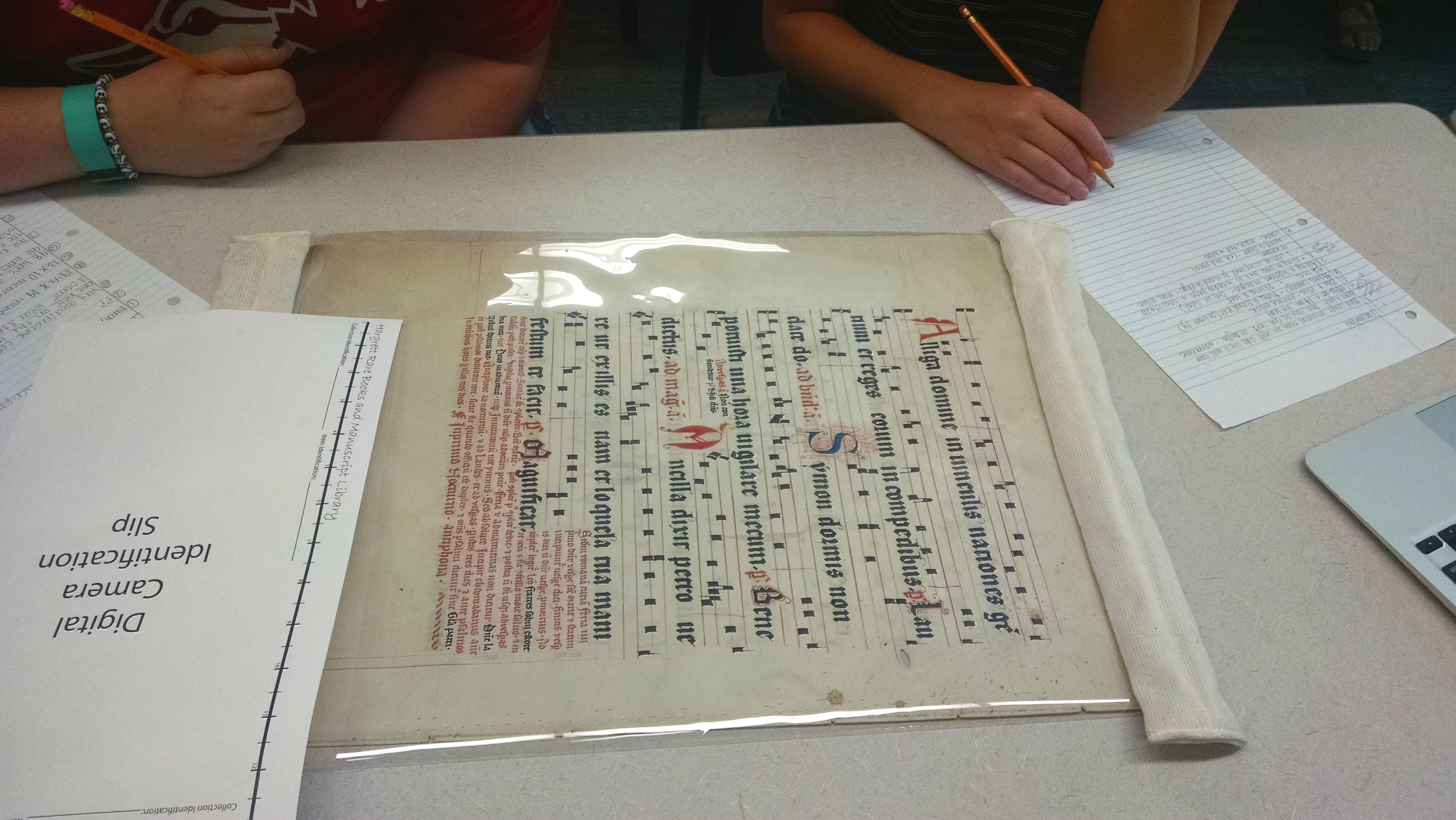 Students examine a fragment of musical notation