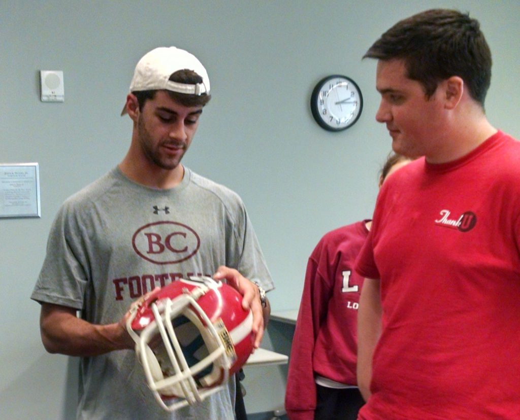 First-Year Odyssey students handle Herschel Walker's helmet