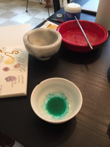 A picture of a bowl of the verdigris powder mixed with egg yolk.