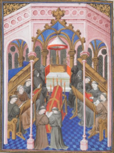 Image of a church inhabited by mourners and monks surrounding a red and gold coffin. Scene from a requiem mass