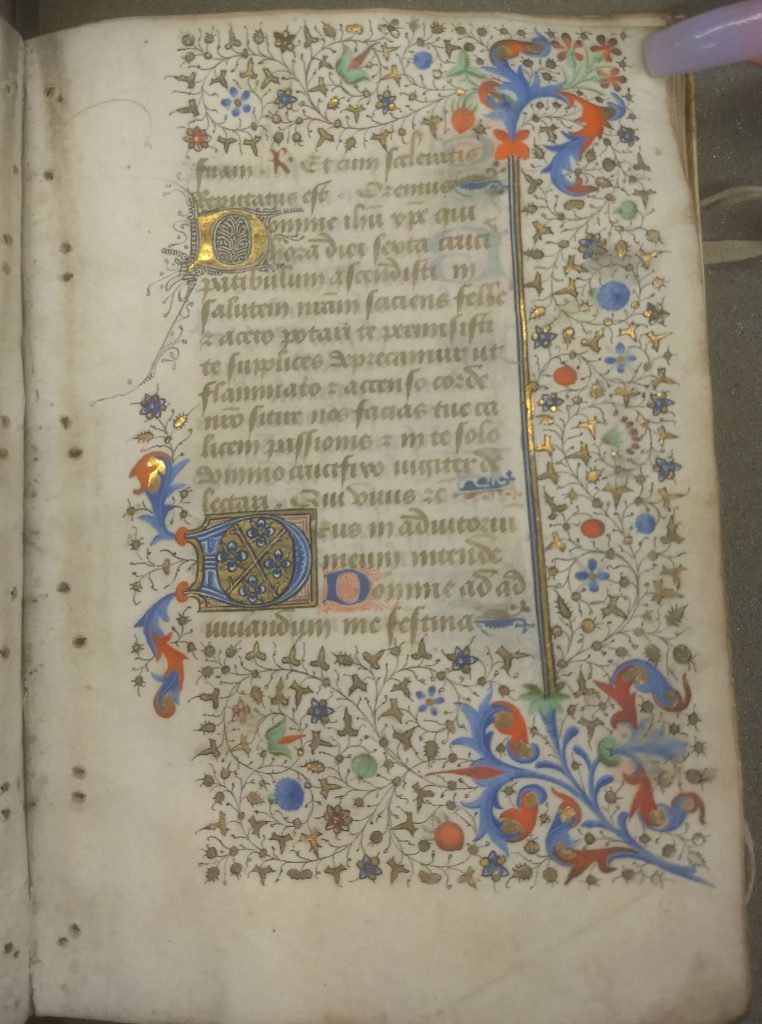 Text page with the back side of the three-sided foliate rinceaux border