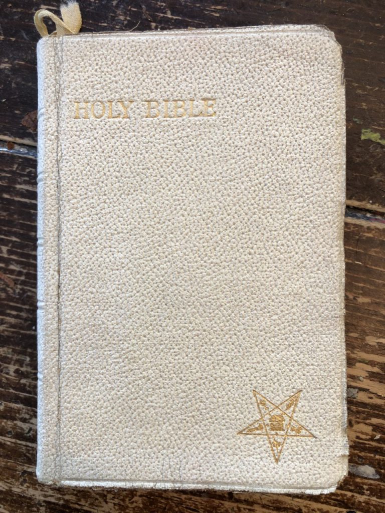 Lilian's lady's Bible. It is small enough to fit in a purse, white, and has a small gold star in the lower right hand corner. 