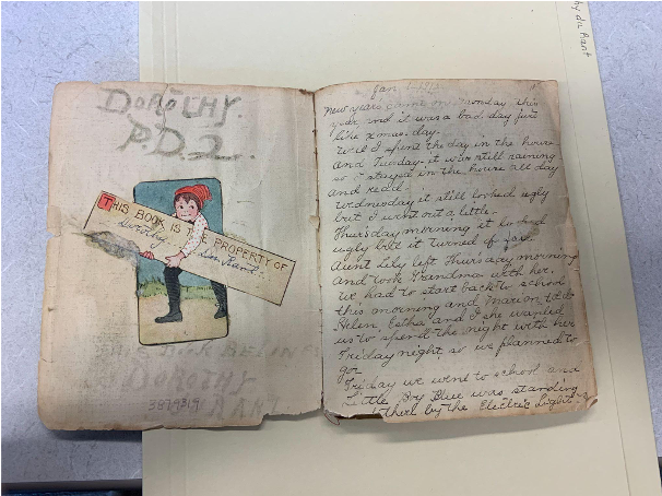 two page opening with book plate on the left and handwriting on the right 