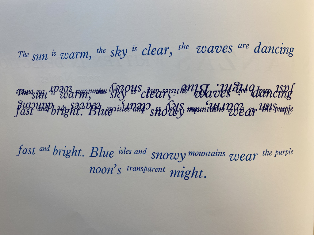'The sun is warm, the sky is clear, the waves are dancing' is written in light blue in alternating small and larger type, followed by a section of dark blue where words overlap chaotically, and then light blue again written "fast and bright. Blue isles and snowy mountains wear the purple noon's transparent might"