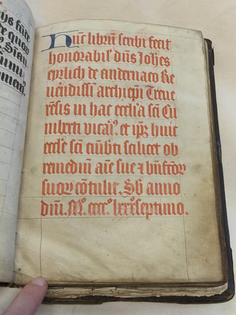 A parchment page with gothic script in oversized red letters.