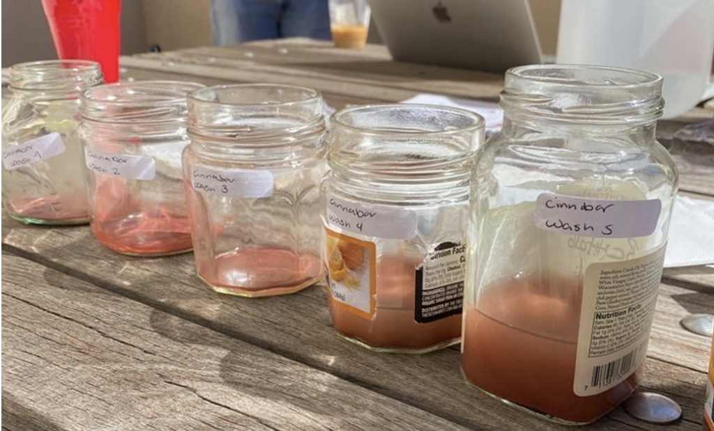 5 glass jars containing various washes of cinnabar labeled 1-5. Each wash is a slightly different shade of red. 