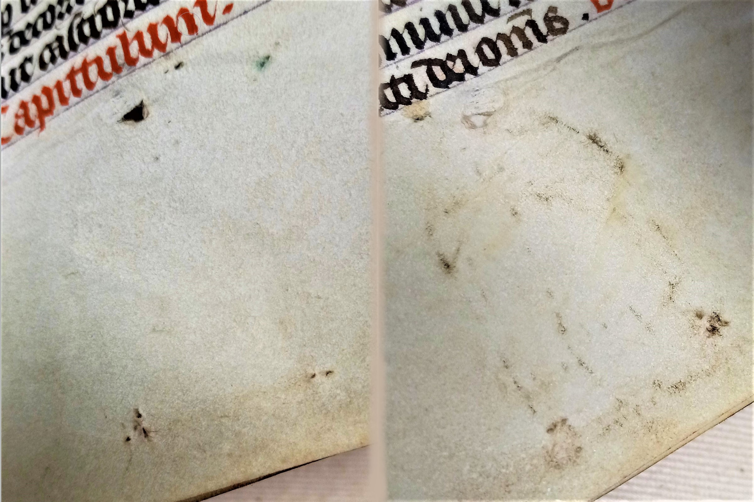 Sewing holes and metal smudges in the bottom margin of a page