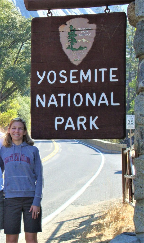 A picture of Dr. Gay, Director of the PACE Lab, at the Yosemite National Park  entrance sign in California. 